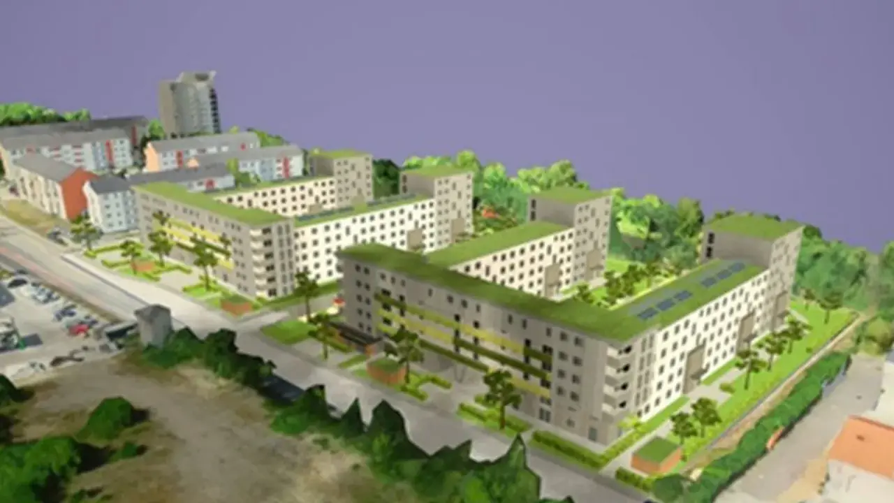 Modell einer integrierten Stadtentwicklung mit begrünten Dächern, Wohnblöcken und Bäumen.