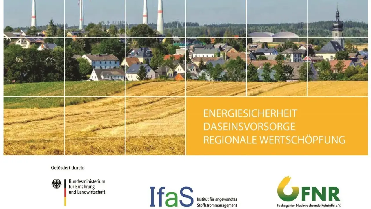 Windräder über einem Dorf und goldenen Feldern. Die Frage, welche erneuerbare Energie die beste ist, wird hier visuell angedeutet.