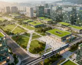 Modellprojekte Smart Cities: Grüne Dächer, vernetzte Gebäude und eine moderne Bahn prägen diese futuristische Stadtlandschaft.