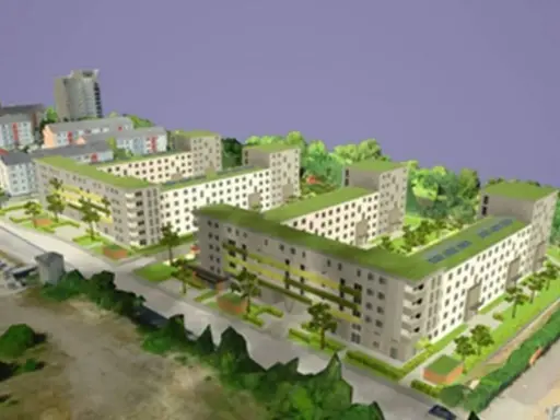 Modell einer integrierten Stadtentwicklung mit begrünten Dächern, Wohnblöcken und Bäumen.