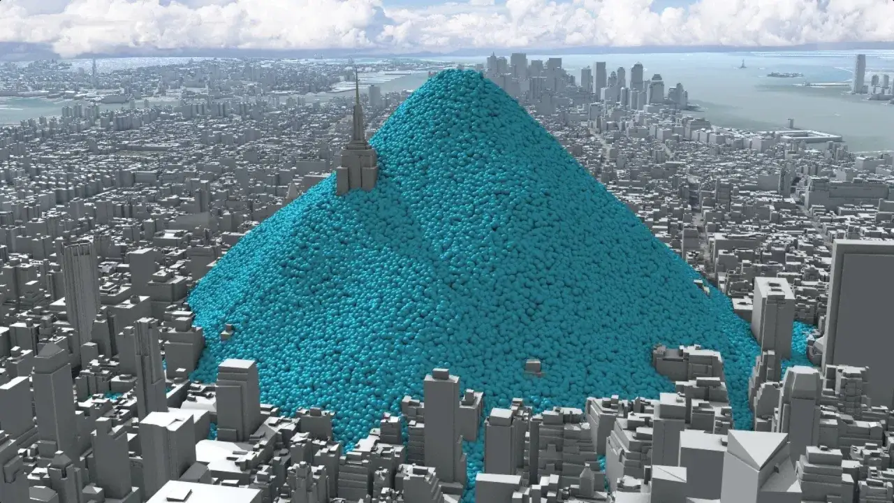 Ein riesiger blauer Berg aus Kugeln, der eine Stadt überragt, veranschaulicht, was eine Tonne CO2 ist.