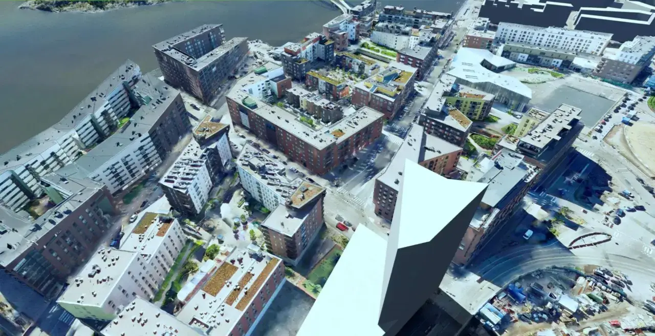 Luftaufnahme einer Stadt mit modernen Geb&auml;uden, die als modellprojekte smart cities dienen.